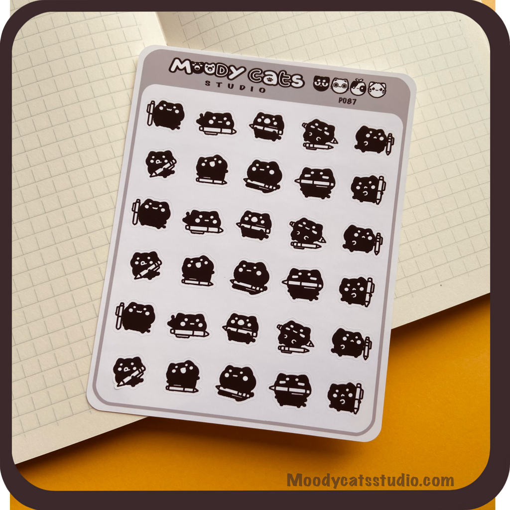 Sticker sheet of a black cat and pens